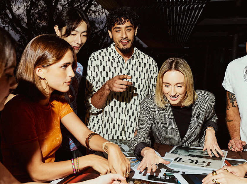 A group of students gathered around a table looking at images - SAE Open House event Perth (1116x6628)