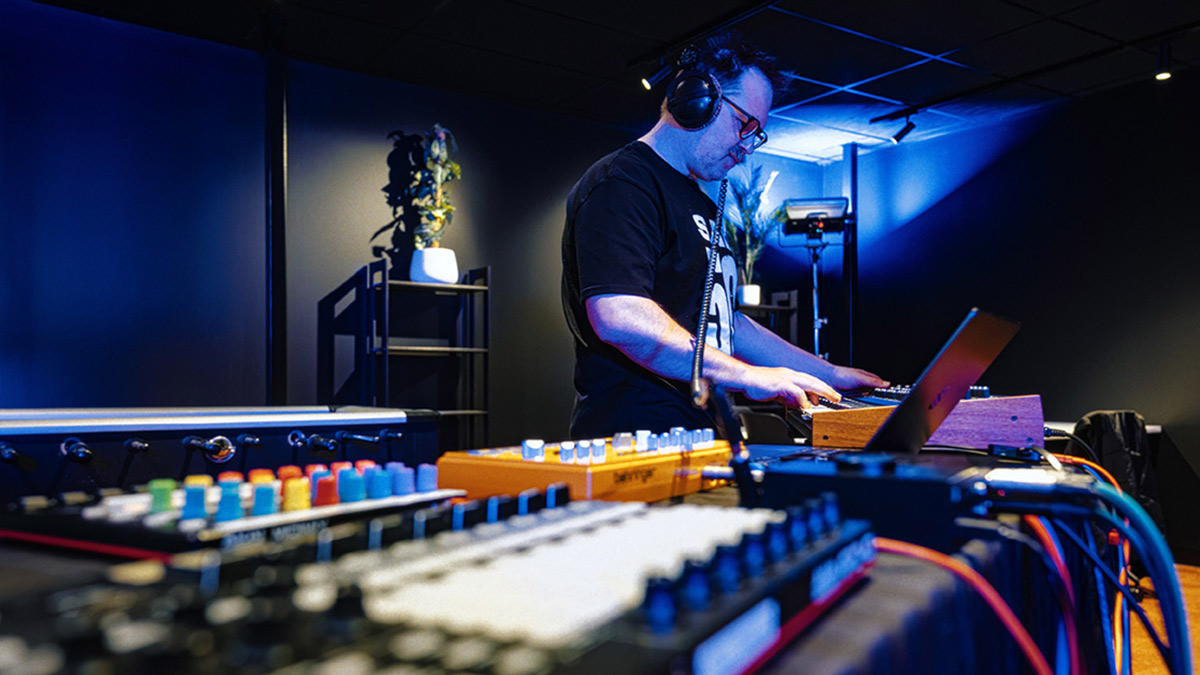 A man working with audio equipment at the Music and Technology Expo (1200x675).